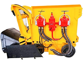 A yellow rock loader at a mine site