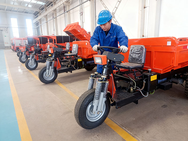 A row of red mining tricycles on display at the factory A row of red mining tricycles on display at the factory