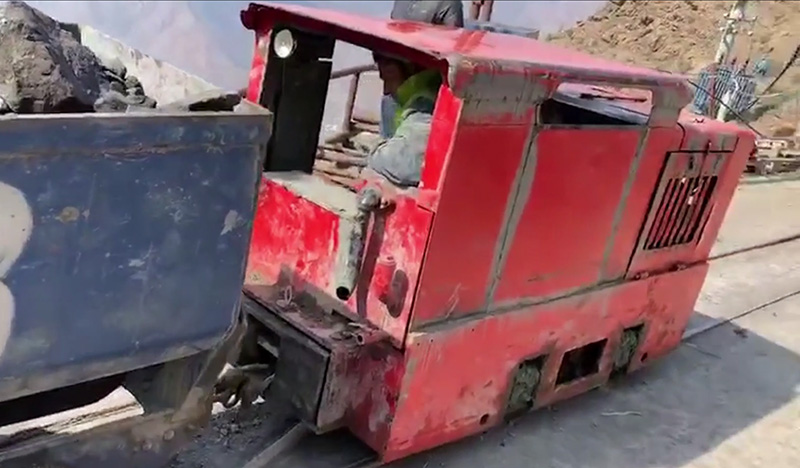 Diesel vs battery mining locomotive comparison scene.