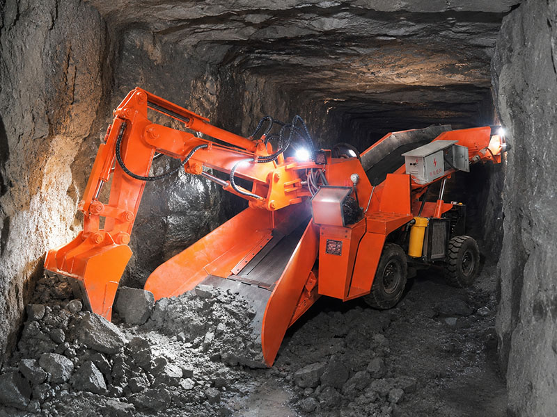 ZWY-50 compact tire-type mucking loader operating in an underground mine tunnel, showcasing its narrow-body design for confined roadways.