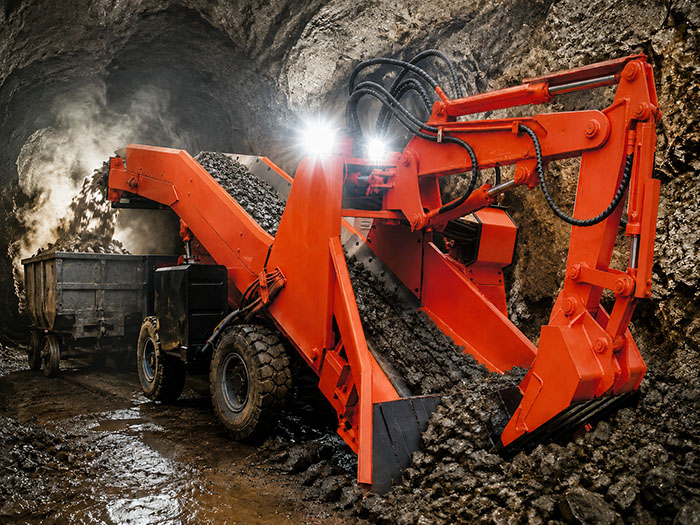 ZWY-50 compact tire-type mucking loader operating in an underground mine tunnel, showcasing its narrow-body design for confined roadways.